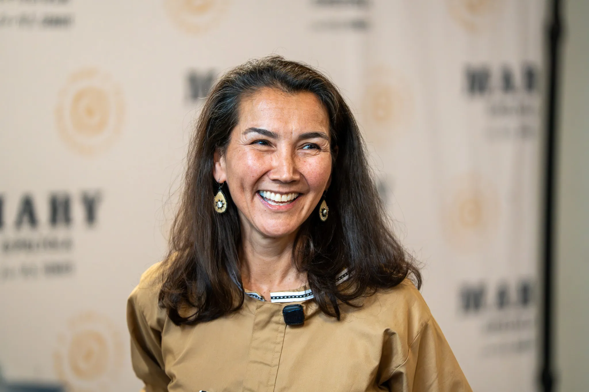 Mary Peltola smiling in front of a Mary Peltola backdrop.