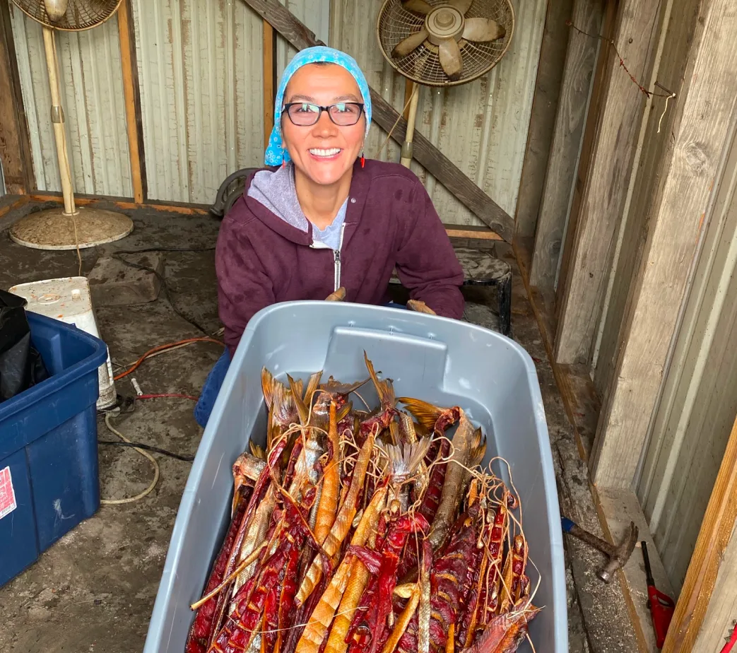 Mary Peltola with a tote of dried salmon at fish camp.