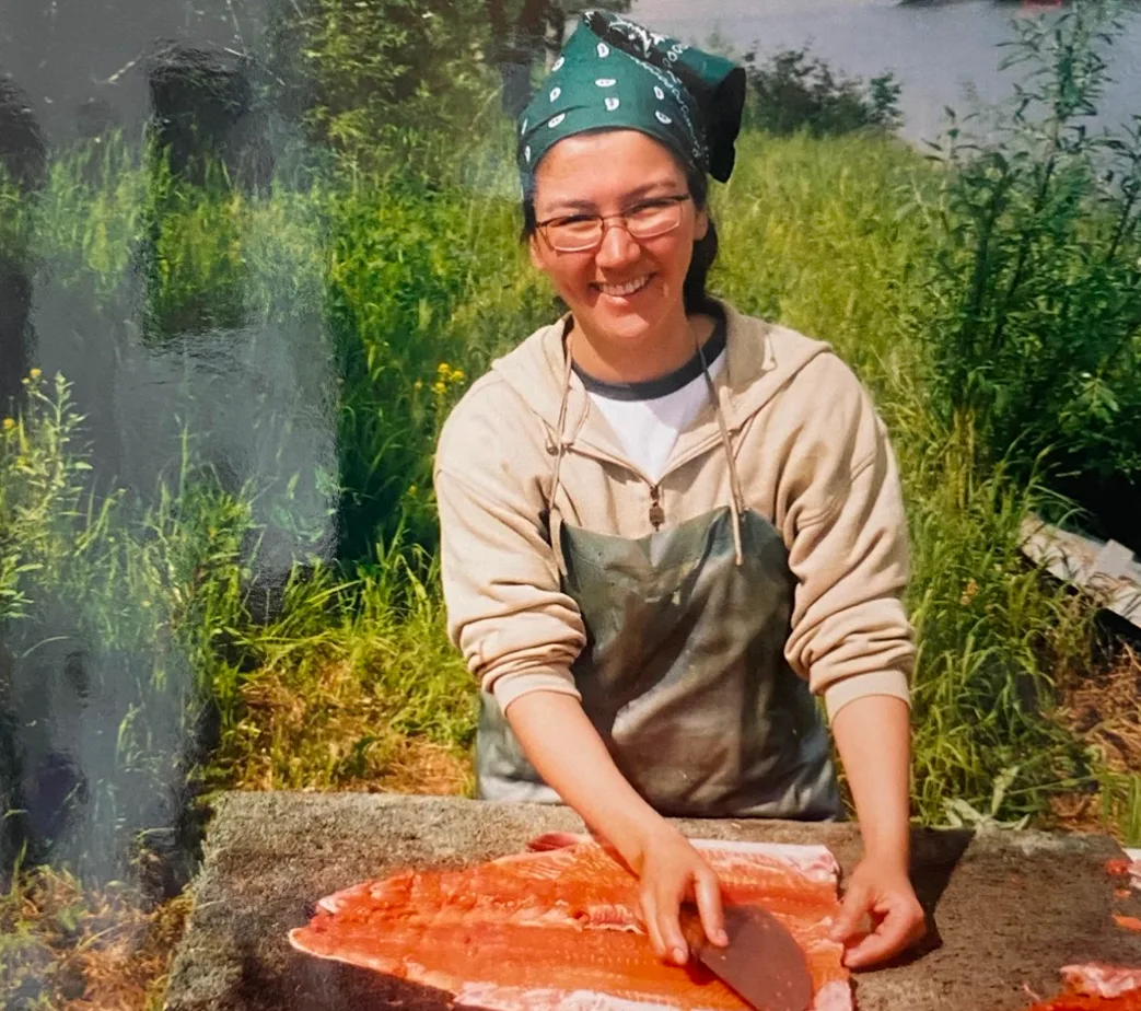 Mary Peltola cutting salmon at fish camp.