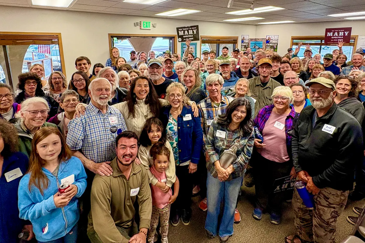 Mary Peltola stands at the center of a packed room of supporters.