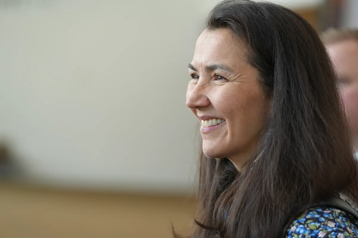Mary Peltola smiles as she listens at an event.