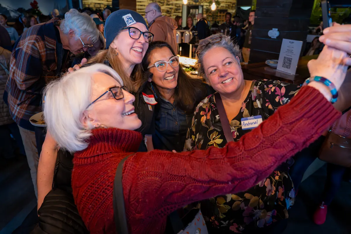 Supporters squeeze in for a selfie with Mary Peltola.