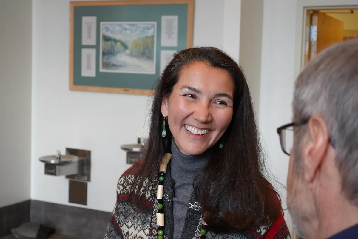 Mary Peltola smiles in conversation with a supporter.
