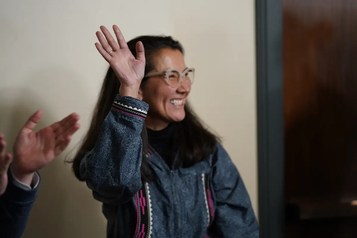 Mary Peltola waves hello to a crowd.