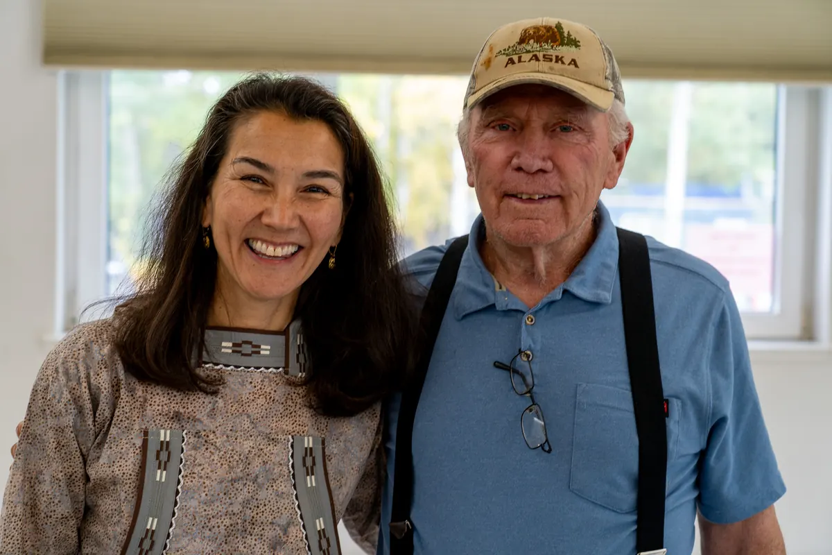 Mary Peltola with an elder in an Alaska cap.