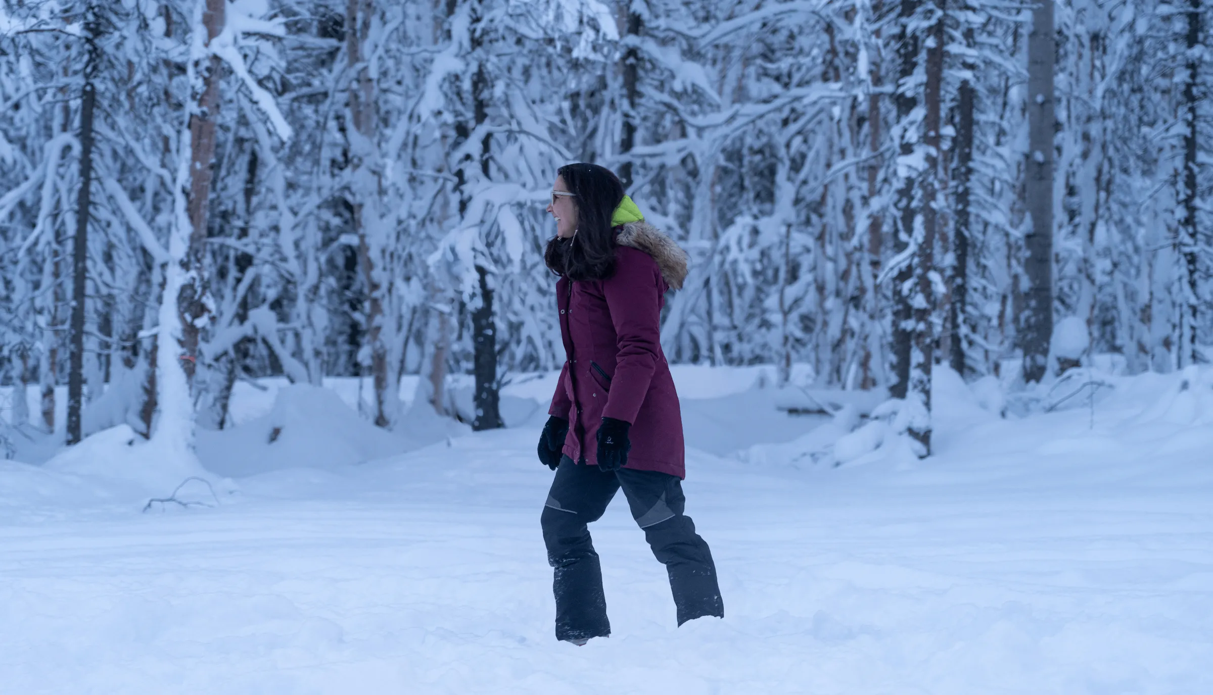 Mary Peltola walking through a snowy Alaska forest.