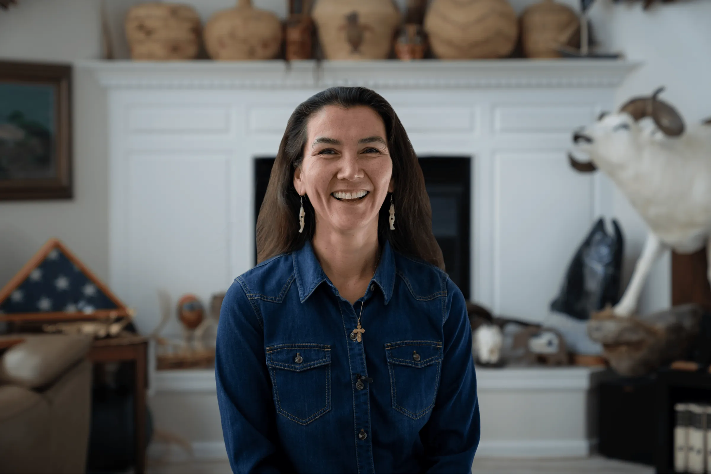 Mary Peltola laughing at home, in a denim shirt.