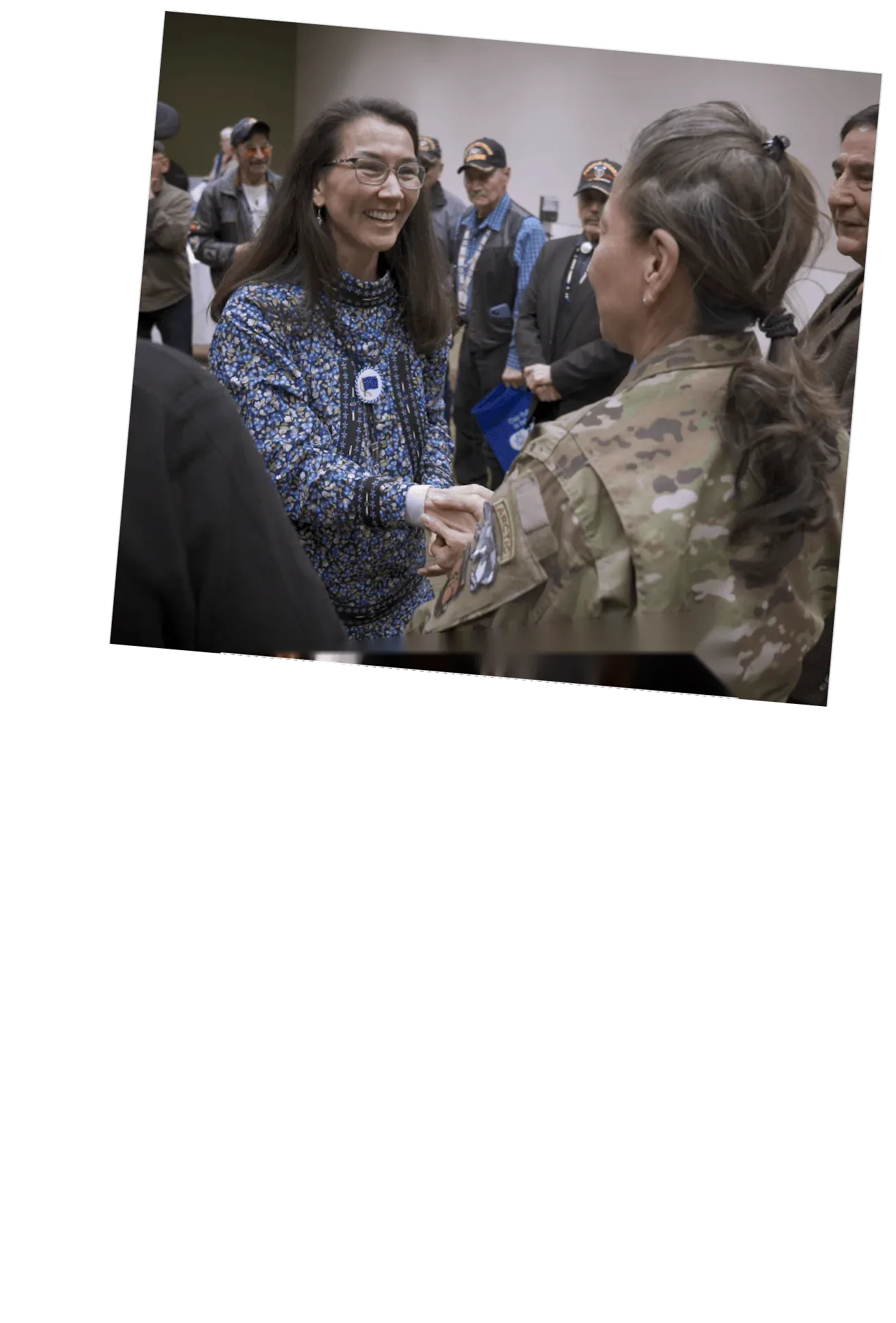 Mary Peltola shaking hands with a servicemember.