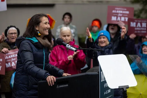 Mary Peltola speaking at a podium among supporters at the rally in Juneau.