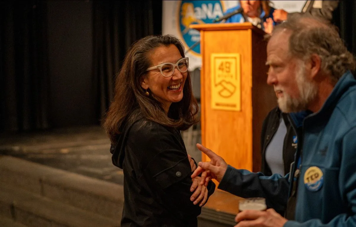 Mary Peltola laughing with a supporter at the town hall in Anchorage.